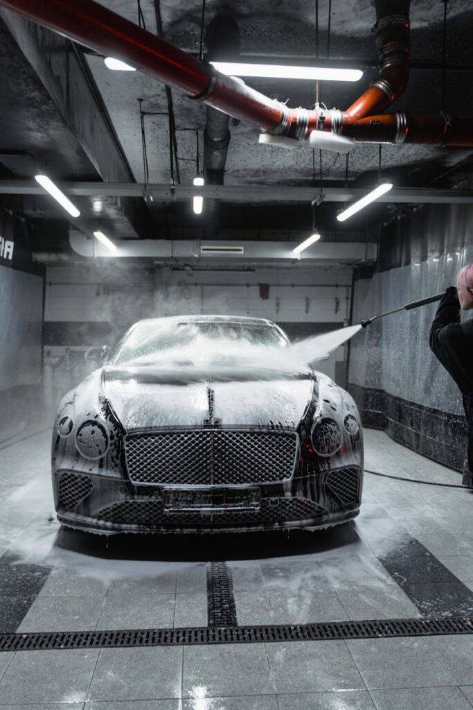 The Ultimate Guide to Choosing the Best Car Wash Soap 2 A Bentley Continental GT being washed with foam and a high-pressure hose in a car wash.