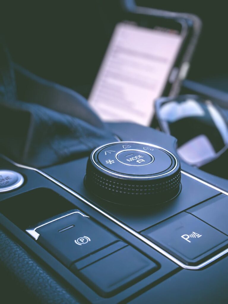 Detailed view of a car's control panel showcasing knobs, buttons, and modern design.
