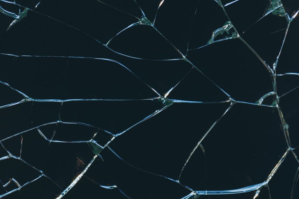 A close up of a broken glass window