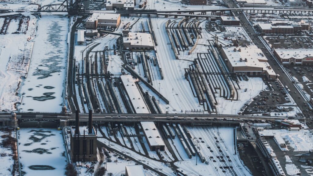 Aerial winter view of snow-covered rail yards and industrial area in Chicago, Illinois.