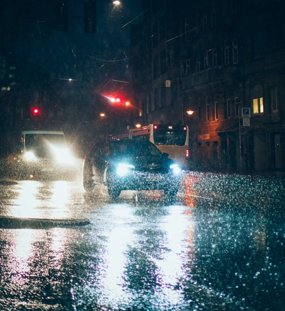water droplets on wet road during night time