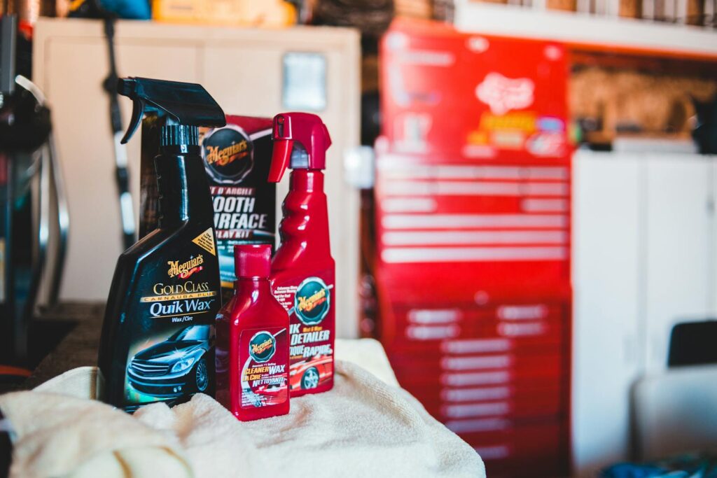 Top Car Cleaning Supplies for At-Home Care in Frederick, MD When You Can't Head To Fusion Car Wash 3 A collection of car care products displayed in a vibrant garage environment.