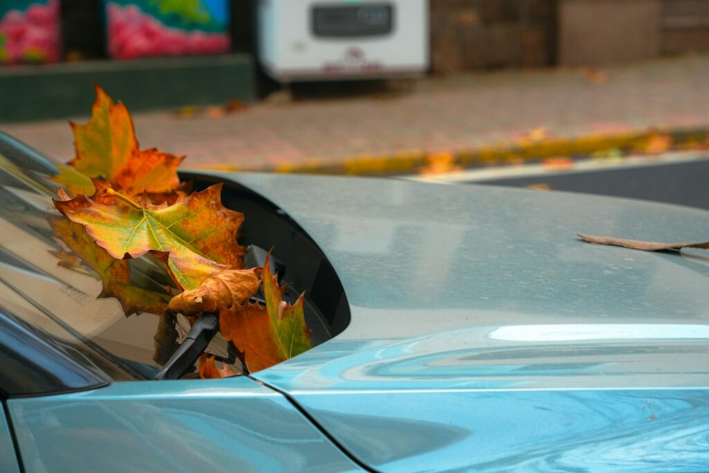 A blue car parked on the side of the road