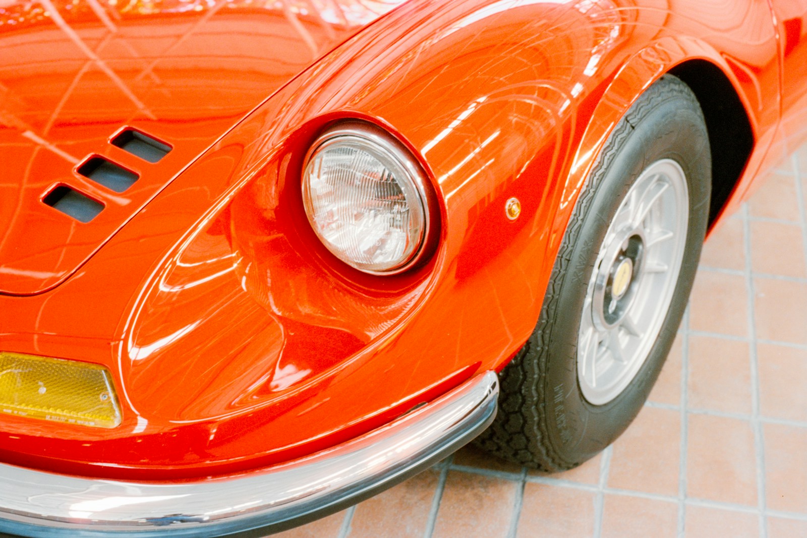 Close-up of a shiny red vintage sports car.
