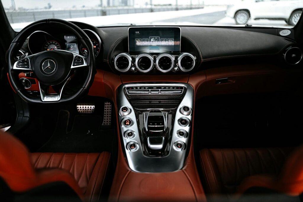 Experience the sleek design and advanced features of a luxury car interior focusing on the dashboard and steering wheel.