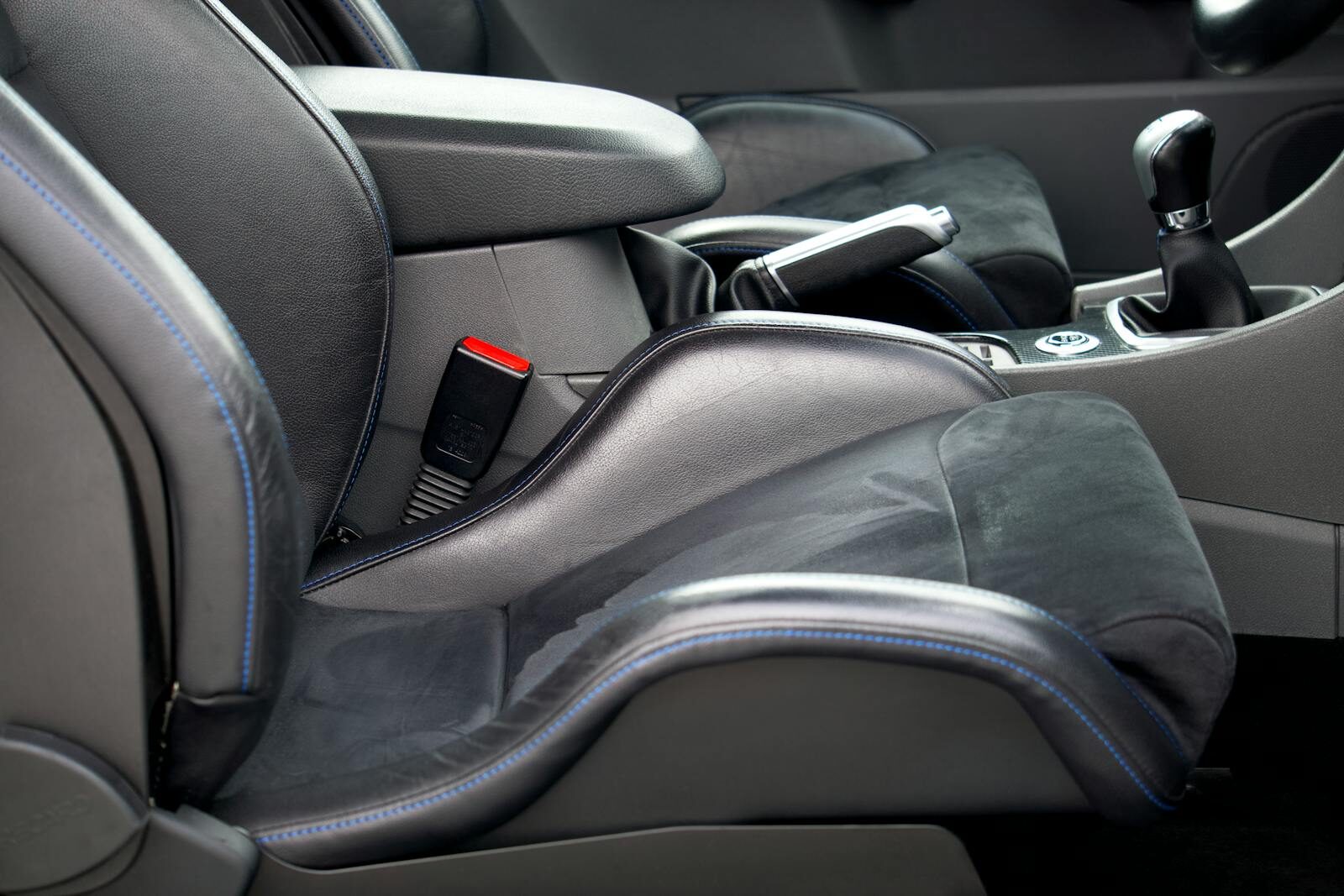 Detailed view of a Ford car's interior focusing on the leather seats and stick shift.