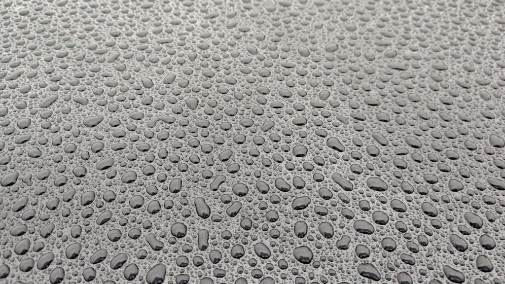 drops of water on the surface of a car