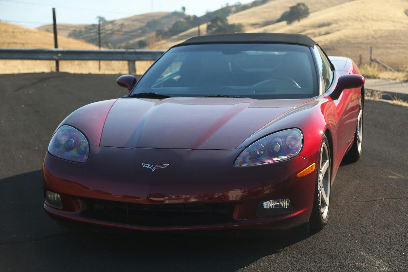 A red sports car driving down a road