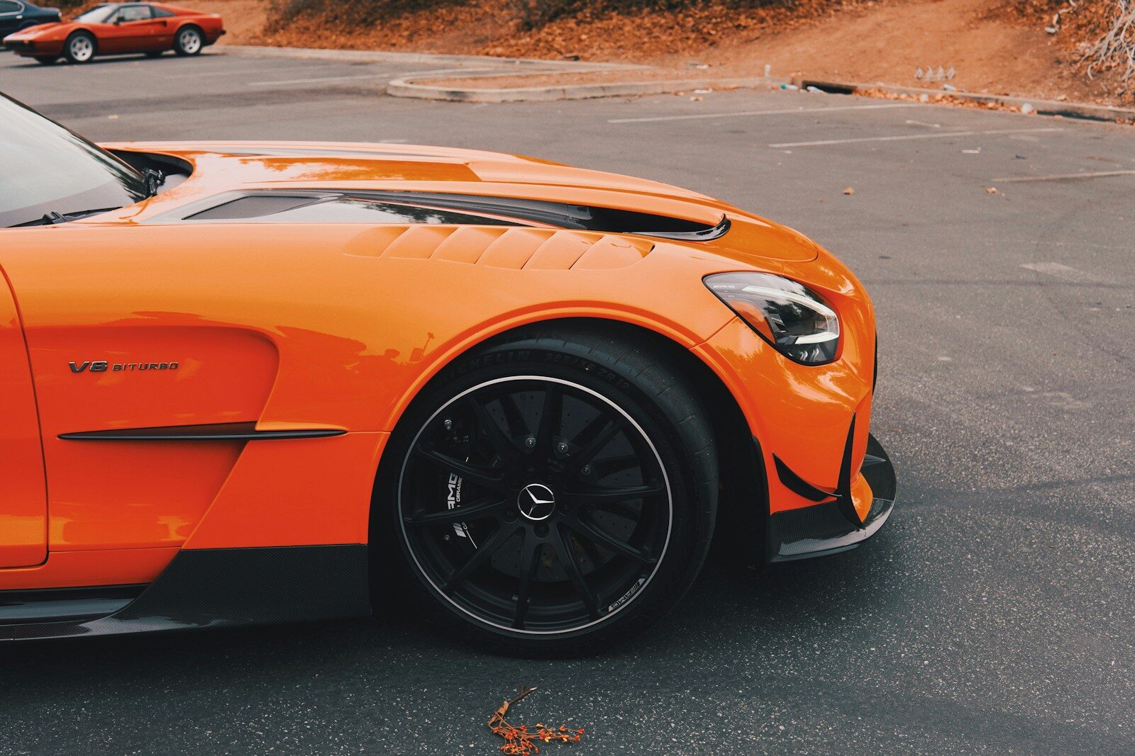 an orange sports car parked in a parking lot
