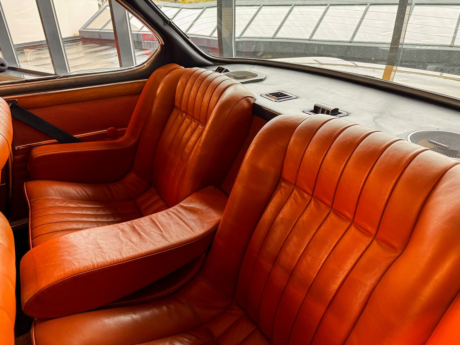 Orange leather car seats in a vintage vehicle