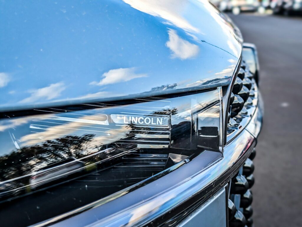 Car Brands Explained: What Matters More Than the Name 2 Close-up of a modern car headlight with lincoln logo