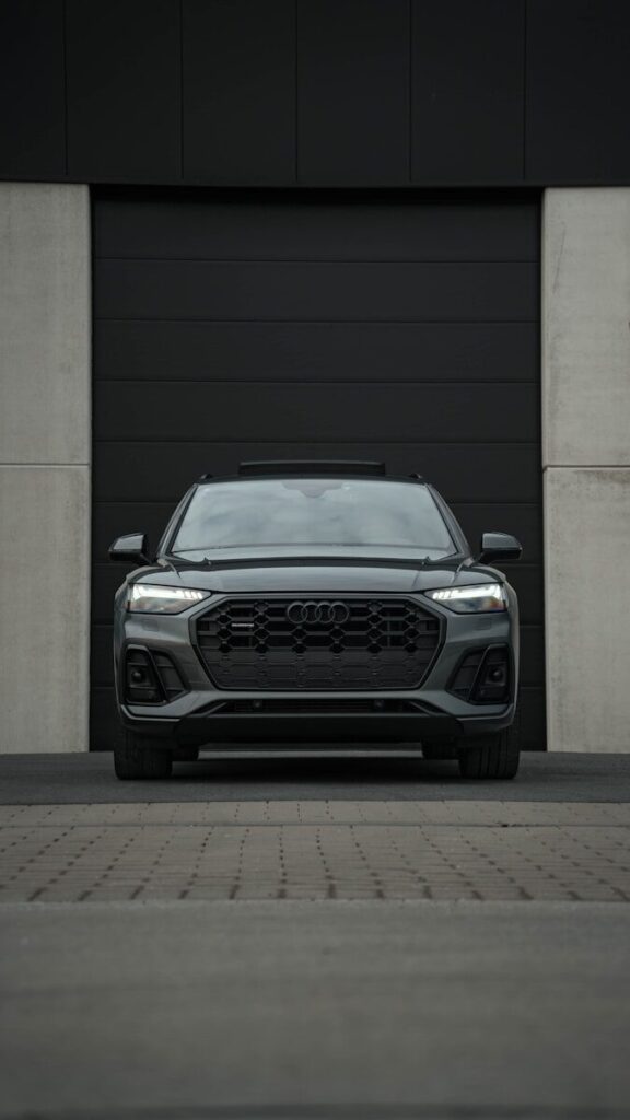 Car Brands Explained: What Matters More Than the Name 1 A dark audi suv parked in front of a garage.